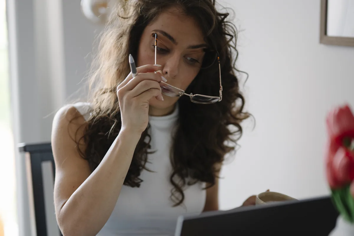 A person reading carefully on a laptop screen